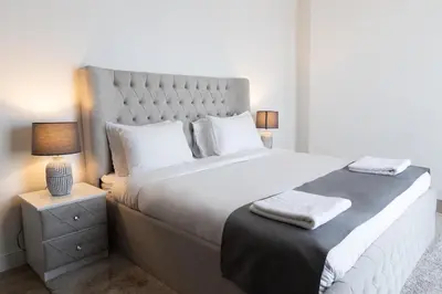 a bedroom with a large white bed with two lamps at Happy Season - Luxury Upgraded 2BR Rimal JBR in Dubai