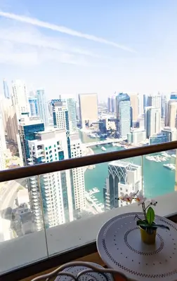 a table in a room with a view of a city at Happy Season - Luxury Upgraded 2BR Rimal JBR in Dubai