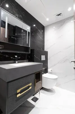 a black bathroom with a sink and a toilet at Happy Season - Luxury Upgraded 2BR Rimal JBR in Dubai