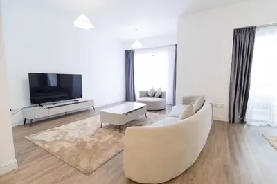 a living room with a couch and a tv at Happy Season - Luxury Upgraded 2BR Rimal JBR in Dubai