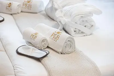 a pair of towels sitting on a bed at PNB Living - Luxury Studio with Canal Views - Trillionaire Residences, Business Bay in Dubai