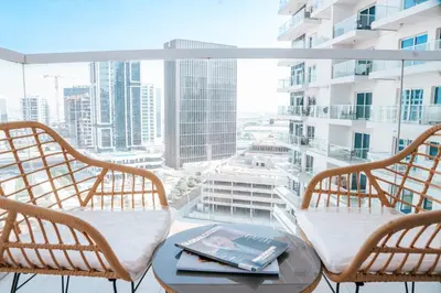 two chairs and a table on a balcony with a view at Skyline Views, Fully Equipped Studio with Balcony, Near Burj Khalifa in Dubai
