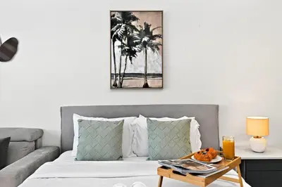 a living room with a bed with a coffee table at Skyline Views, Fully Equipped Studio with Balcony, Near Burj Khalifa in Dubai