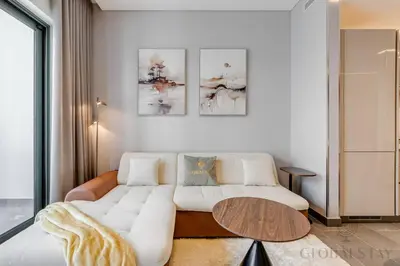 a living room with a white couch and a table at GlobalStay The Crest Tower C Apartments Dubai in Dubai