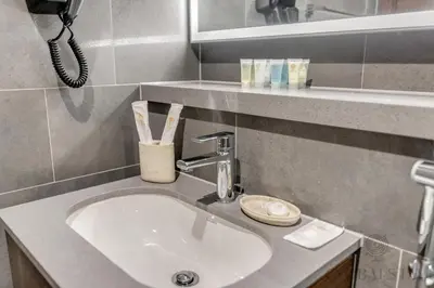 a bathroom counter with a sink and a phone at GlobalStay The Crest Tower C Apartments Dubai in Dubai