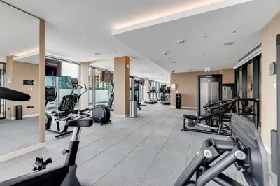 a gym with cardio equipment in a building at GlobalStay The Crest Tower C Apartments Dubai in Dubai
