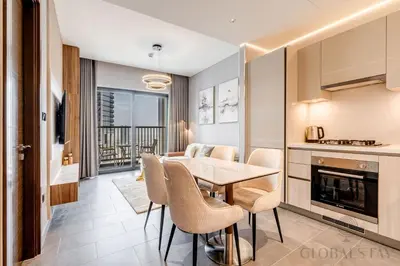 a kitchen and dining room with a table and chairs at GlobalStay The Crest Tower C Apartments Dubai in Dubai