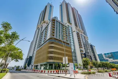 a tall building with many windows on a street at GlobalStay The Crest Tower C Apartments Dubai in Dubai