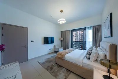 a bedroom with a large bed and a large window at Act 2 - Luxury 2BR Facing Burj Khalifa & Fountain in Dubai