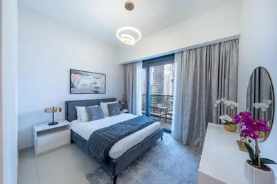 a bedroom with a bed and a large window at Act 2 - Luxury 2BR Facing Burj Khalifa & Fountain in Dubai