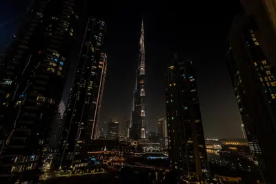 a view of a city at night with the shard at Act 2 - Luxury 2BR Facing Burj Khalifa & Fountain in Dubai