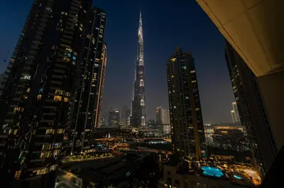 a view of a city skyline at night at Act 2 - Luxury 2BR Facing Burj Khalifa & Fountain in Dubai