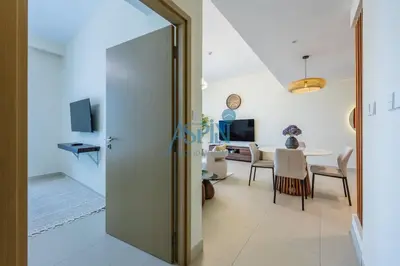 a living room with a table and a dining room at Aspin 1BHK Waterfront View - Creek Horizon in Dubai