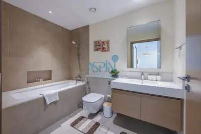 a bathroom with a tub and a toilet and a sink at Aspin 1BHK Waterfront View - Creek Horizon in Dubai