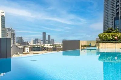 a large swimming pool on the roof of a building at Cosmic Address 2BR Burj Views above Dubai Mall - By Maxx Value Homes in Dubai