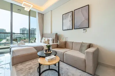a living room with a couch and a bed at Walking distance to Dubai Miracle Garden and Butterfly Garden, Few minutes drive to Mall of the Emirates and IMG Worlds of Adventure - Samana Park Views, Arjan by Deluxe Holiday Homes in Dubai