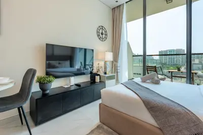a bedroom with a large bed and a large window at Walking distance to Dubai Miracle Garden and Butterfly Garden, Few minutes drive to Mall of the Emirates and IMG Worlds of Adventure - Samana Park Views, Arjan by Deluxe Holiday Homes in Dubai