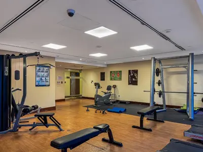 a gym with several treadmills and exercise equipment at Modern 1 Bed With Marina Views Near JBR Beach in Dubai