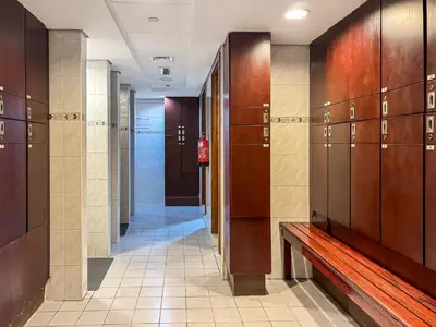 a hallway with wooden lockers and a bench in a building at Modern 1 Bed With Marina Views Near JBR Beach in Dubai