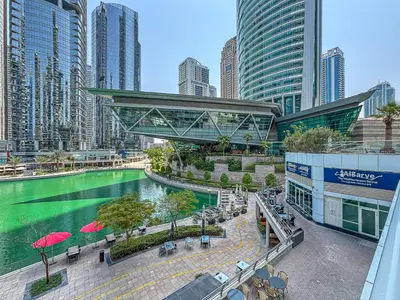 a view of a river in a city with tall buildings at Modern 1 Bed With Marina Views Near JBR Beach in Dubai