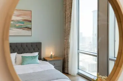 a bedroom with a bed and a large window at Bellaviu Holiday Homes,1BR Elegant Stay, Noora Tower, Business Bay in Dubai