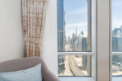 a room with a window with a view of a city at Bellaviu Holiday Homes,1BR Elegant Stay, Noora Tower, Business Bay in Dubai