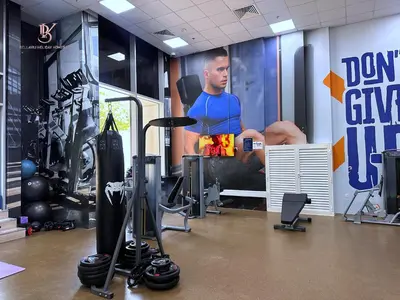 a gym with a picture of a man on the wall at Bellaviu Holiday Homes,1BR Elegant Stay, Noora Tower, Business Bay in Dubai