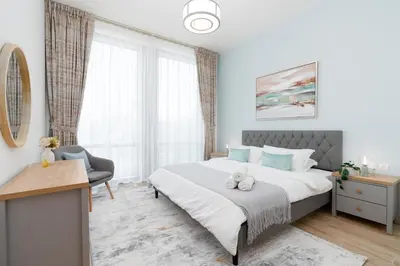 a bedroom with a bed and a desk and window at Bellaviu Holiday Homes,1BR Elegant Stay, Noora Tower, Business Bay in Dubai