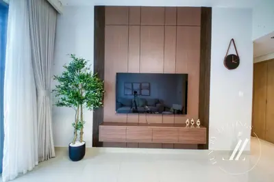 a living room with a large flat screen tv at Luxury 1BR Harbour Views Tower 2 Creek Harbour Dubai in Dubai