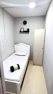 a small room with a bed with a bottle on it at Eco Space Partition Room in Green view 3 in Dubai
