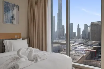 two swans towels on a bed in a hotel room at Luxury-Brand New-Direct Access toThe Dubai Mall in Dubai