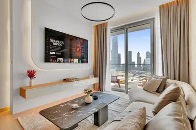 a living room with a couch and a tv at Luxury-Brand New-Direct Access toThe Dubai Mall in Dubai