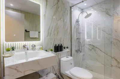 a bathroom with a sink and a toilet and a mirror at The Lofts Downtown - Stunning Burj Khalifa View in Dubai