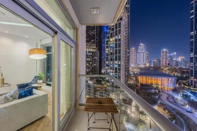 a balcony with a view of a city at night at The Lofts Downtown - Stunning Burj Khalifa View in Dubai