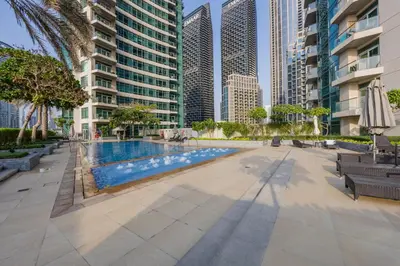a swimming pool in a city with tall buildings at The Lofts Downtown - Stunning Burj Khalifa View in Dubai