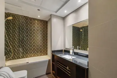 a bathroom with a sink and a mirror at 2BR In The World-Famous Twisted Skyscraper in Dubai