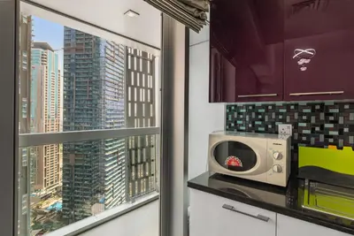 a kitchen with a view of a city skyline at 2BR In The World-Famous Twisted Skyscraper in Dubai