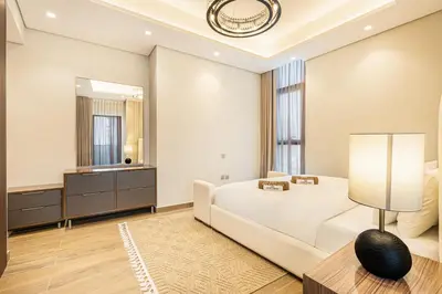 a bedroom with a white bed and a mirror at Premium Central Home with Burj Khalifa View in Dubai