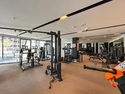 a gym with several treadmills and machines at Premium Central Home with Burj Khalifa View in Dubai