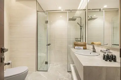 a bathroom with a shower and a toilet and a sink at Premium Central Home with Burj Khalifa View in Dubai