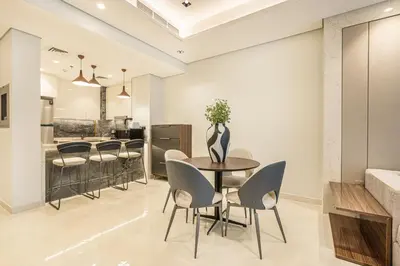 a dining room with a table and chairs at Premium Central Home with Burj Khalifa View in Dubai