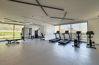 a gym with treadmills and cardio equipment in a building at Close to Dubai Miracle Garden, Dubai Autodrome, and Sports City, with JVT Community Park just steps away - The Ivy, Jumeirah Village Triangle by Deluxe Holiday Homes in Dubai