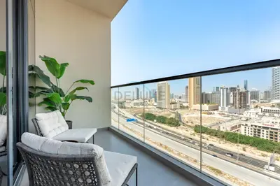 a living room with a view of a city at Close to Dubai Miracle Garden, Dubai Autodrome, and Sports City, with JVT Community Park just steps away - The Ivy, Jumeirah Village Triangle by Deluxe Holiday Homes in Dubai
