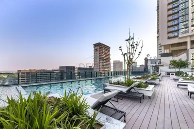 a swimming pool on the roof of a building at High-Floor 2BR with Skyline Views, Steps from a Park, Minutes Drive to Meydan Golf Club and Ras Al Khor Wildlife Sanctuary, Sobha Hartland The Crest Tower C, Sobha Hartland by Deluxe Holiday Homes in Dubai