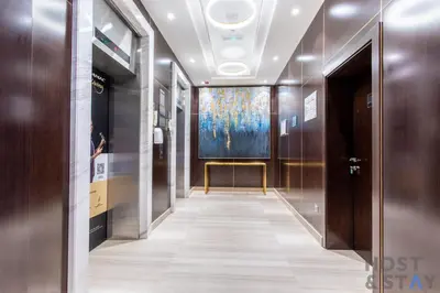 a hallway with a painting on the wall at Cozy Studio in Orchid - Damac Hills Dubai in Dubai
