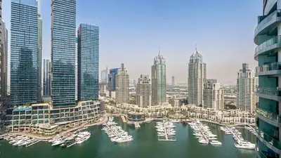 a view of a city with boats in a harbor at Luxury Stay 1BR, Waterfront in Marina LIV Tower - 20AB05 in Dubai