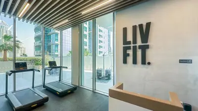 a gym with two elliptical machines in a building at Luxury Stay 1BR, Waterfront in Marina LIV Tower - 20AB05 in Dubai