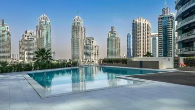a swimming pool in a city with tall buildings at Luxury Stay 1BR, Waterfront in Marina LIV Tower - 20AB05 in Dubai