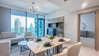 a dining room with a table and chairs and a couch at Luxury Stay 1BR, Waterfront in Marina LIV Tower - 20AB05 in Dubai