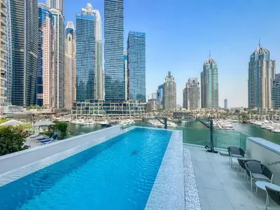 a swimming pool on the roof of a building with a city at Exclusive Marina Lifestyle with Stunning Views in Dubai